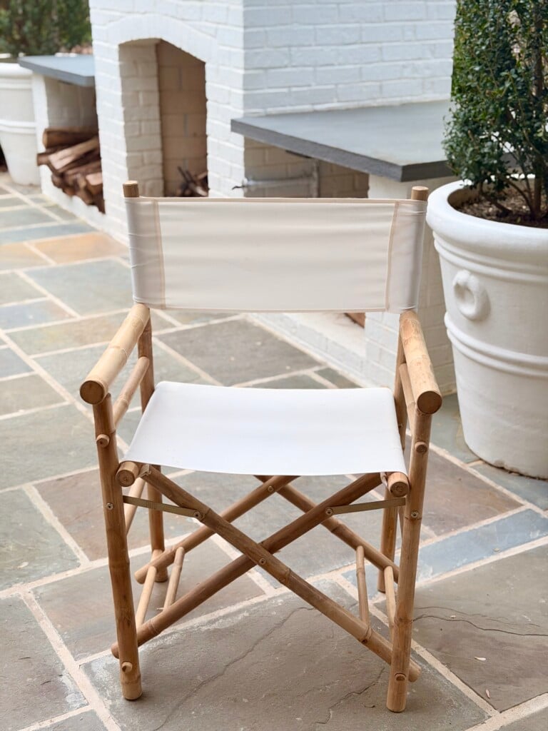 Close up of Yohana folding director chair with bamboo frame and white canvas seat